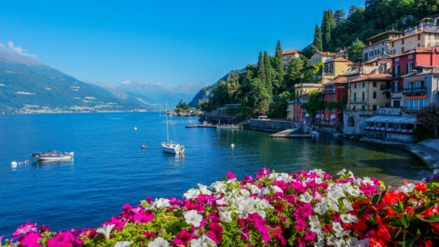 Lake Como with flowers in foreground, blue sky
