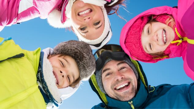 Family looking at camera, winter clothing