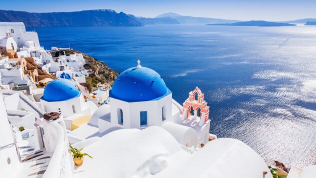 Oia Village and Santorini caldera on sunny day