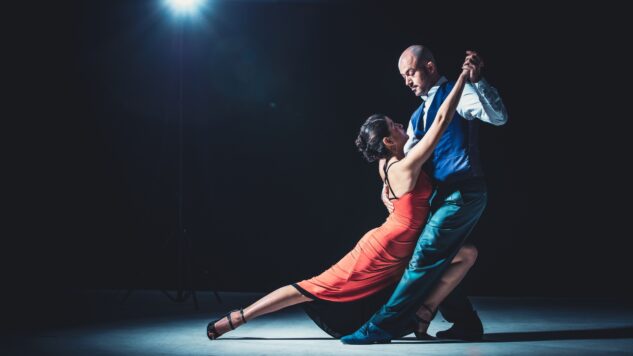 woman and man dancing under spotlight