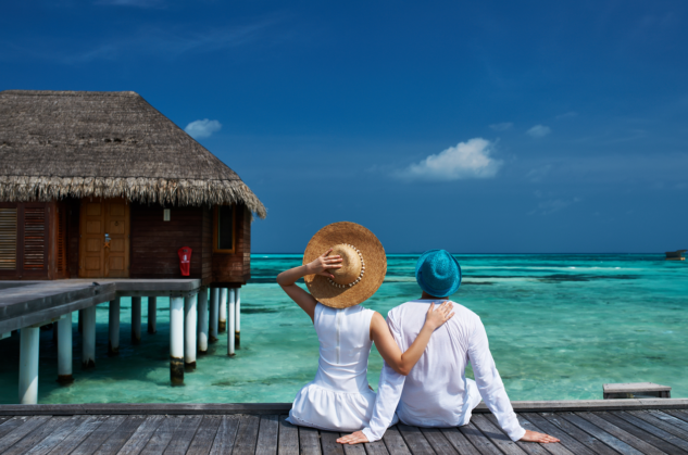 Couple in the Maldives sitting looking out to sea