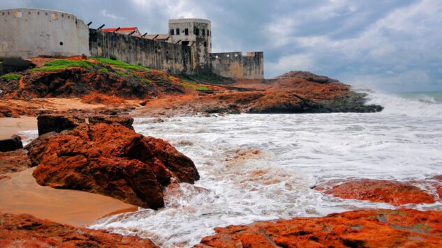 Cape Coast Castle with the ocean and red rocks