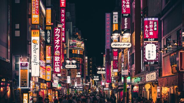 tokyo at night with people walking down street