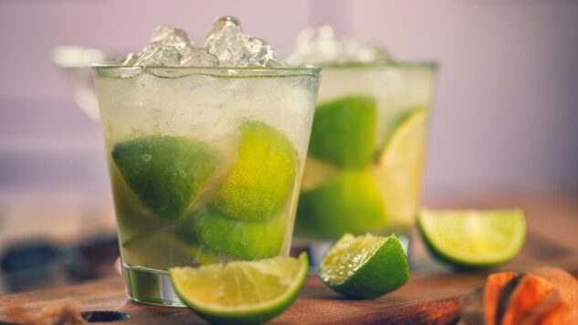 Two caipirinha cocktails with lime