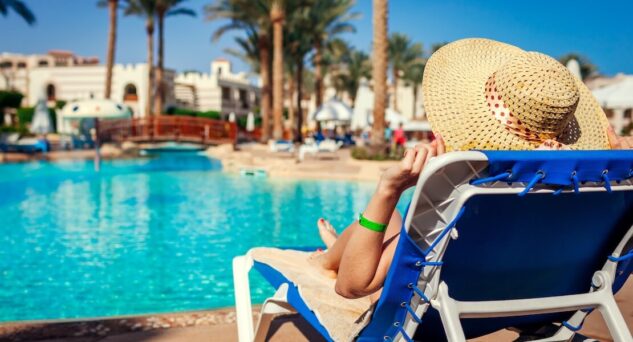 A person on a poolside sun lounger.